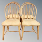 A set of four beech spindle backed dining chairs