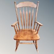 A stained beech wood rocking chair