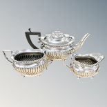 A silver three-piece tea service, Joseph Gloster Ltd, Birmingham 1909,