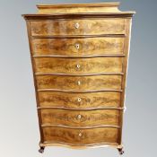 A Continental serpentine seven drawer chest,