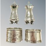 A pair of silver sifters and two silver napkin rings.