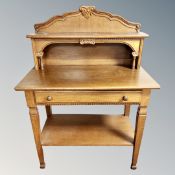 An oak side table fitted a drawer with undershelf,