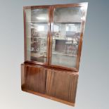 A continental mahogany glazed bookcase fitted with cupboards,