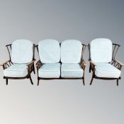An Ercol stained elm three piece suite comprising of two seater settee and matching pair of chairs