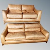 A tan leather three seater settee and matching two seater settee