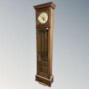 A continental oak longcase clock with silvered and brass dial,