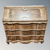 A 19th century continental oak and parcel gilt serpentine fronted bureau,