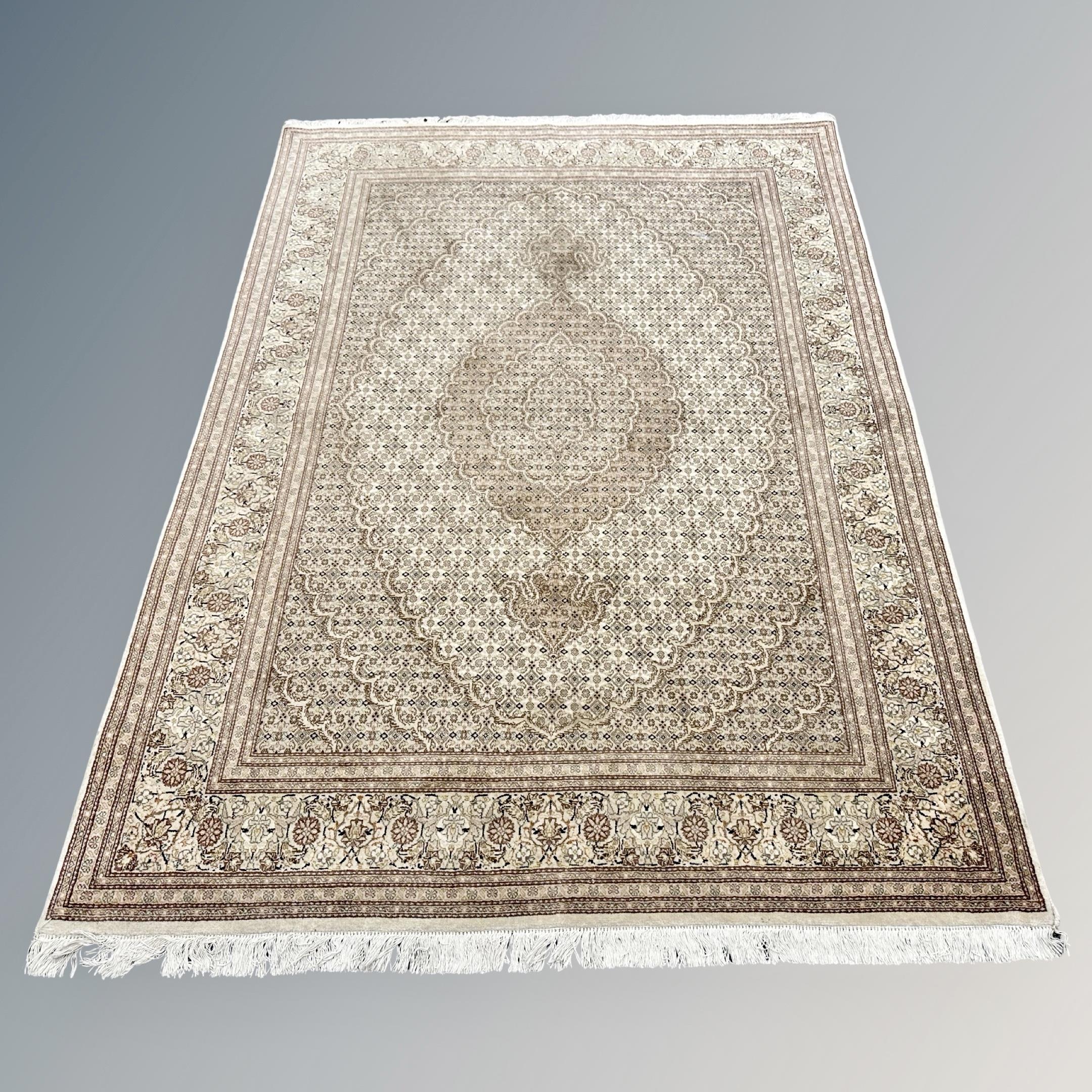 An Indian rug of Tabriz-design, on cream ground,