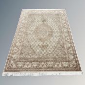 An Indian rug of Tabriz-design, on cream ground,