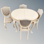 A cream and gilt circular dining table on cabriole legs together with a set of four dining chairs