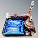 A gilt purple tinted glass decanter and six similar glasses, paperweight,