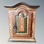A 19th century Continental painted single door wall cabinet