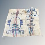 Two 70 KG hessian rice sacks, with stencilled product markings, each 90 cm x 70 cm.