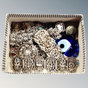 A box of decorative white metal and silver bracelets