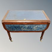 A drop leaf Regency style low table with blue leather inset panel top