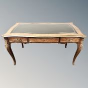 A reproduction French kingwood veneered and brass mounted bureau-plat fitted with three drawers,