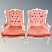 A pair of cream and gilt wing backed armchairs in pink buttoned dralon