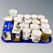 A tray of commemorative mugs,