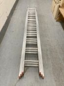 An aluminium triple extension ladder, length 280 cm.
