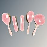 An five-piece enamel and silver dressing table set, with rose pink guilloche enamel,