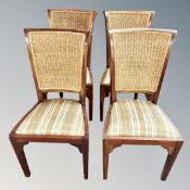A set of four contemporary cane backed dining chairs