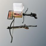 An Anglo Arms pistol crossbow, another similar and a box of bolts.