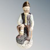 A large pottery figures of a miner,
