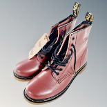 A pair of Dr Marten's red leather boots,