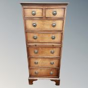 A reproduction mahogany seven drawer chest
