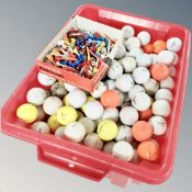 A box of golf balls and tees