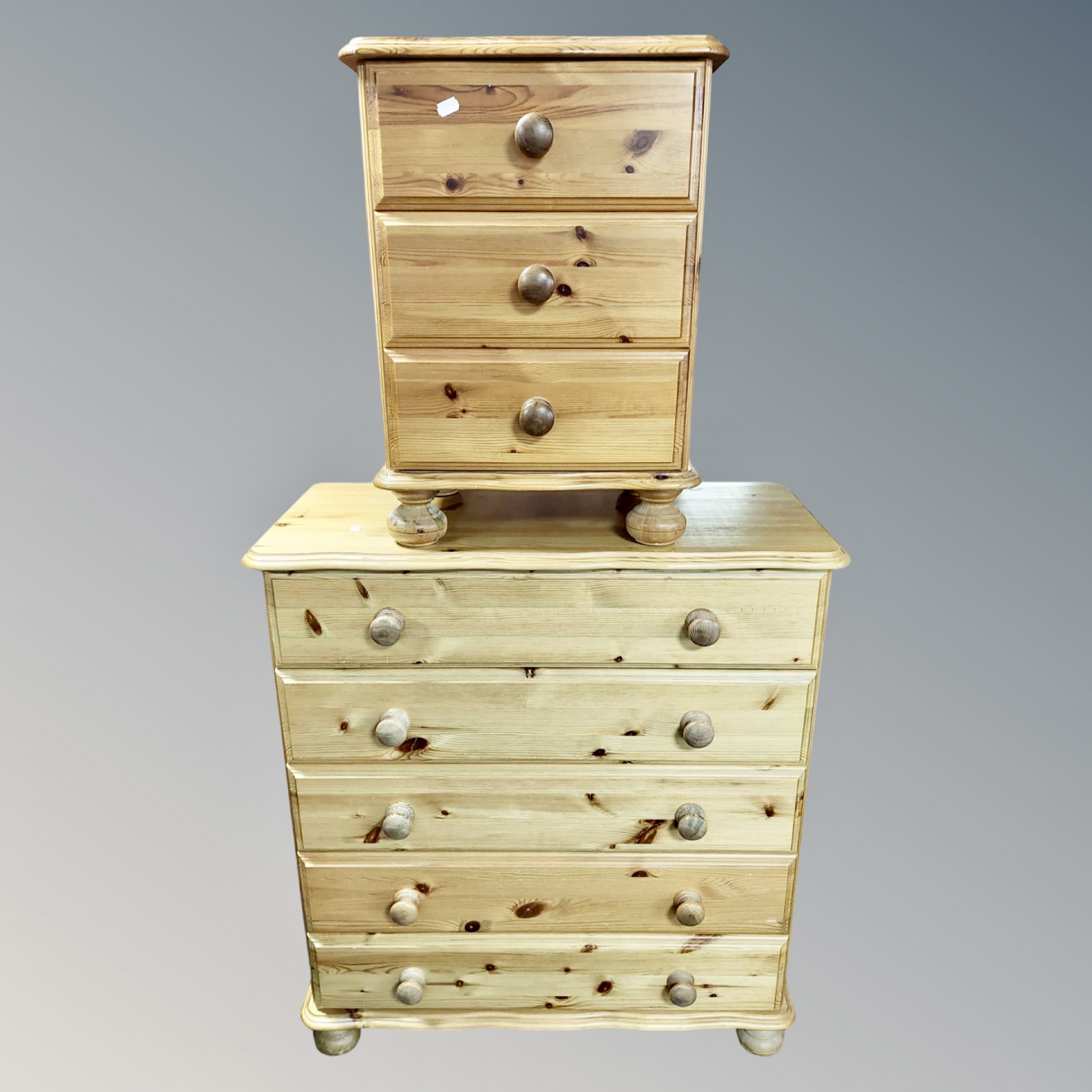 A contemporary pine five drawer chest and matching three drawer chest