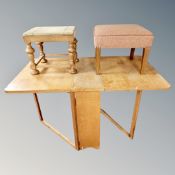 A continental oak drop leaf table together with two stools