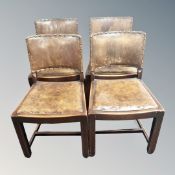 A set of four oak and studded brown leather dining chairs