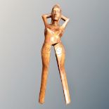 A carved wooden nut cracker in the form of a woman,
