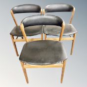 A pair of continental black vinyl elbow chairs