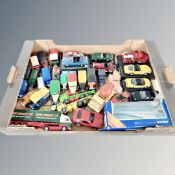 A box of mostly un-boxed die cast vehicles, classic cars on plinths,
