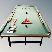 A snooker table with accessories,