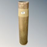 A large brass ammunition shell,