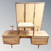 A 1970's teak triple wardrobe with matching dressing table (lacking mirror back) and stool