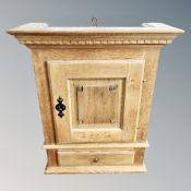 A 19th century oak hanging wall cabinet,