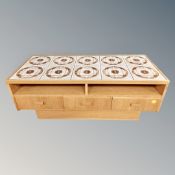 A continental tiled top coffee table fitted with drawers