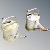Two galvanized watering cans