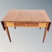 A continental mahogany drop end low table fitted with a drawer