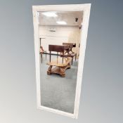 A cream and gilt framed bevelled mirror 162 cm x 72 cm