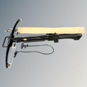 A crossbow with several bolts and drawing pull cord.
