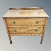 An Edwardian oak two drawer chest