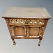 A reproduction oak side cabinet,