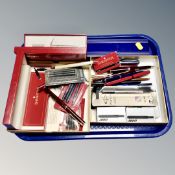 A tray of writing utensils including fountain & ball point pens,