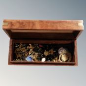 A table box with brass inlay containing a large amount of badges, pins,