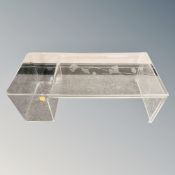 A clear perspex coffee table